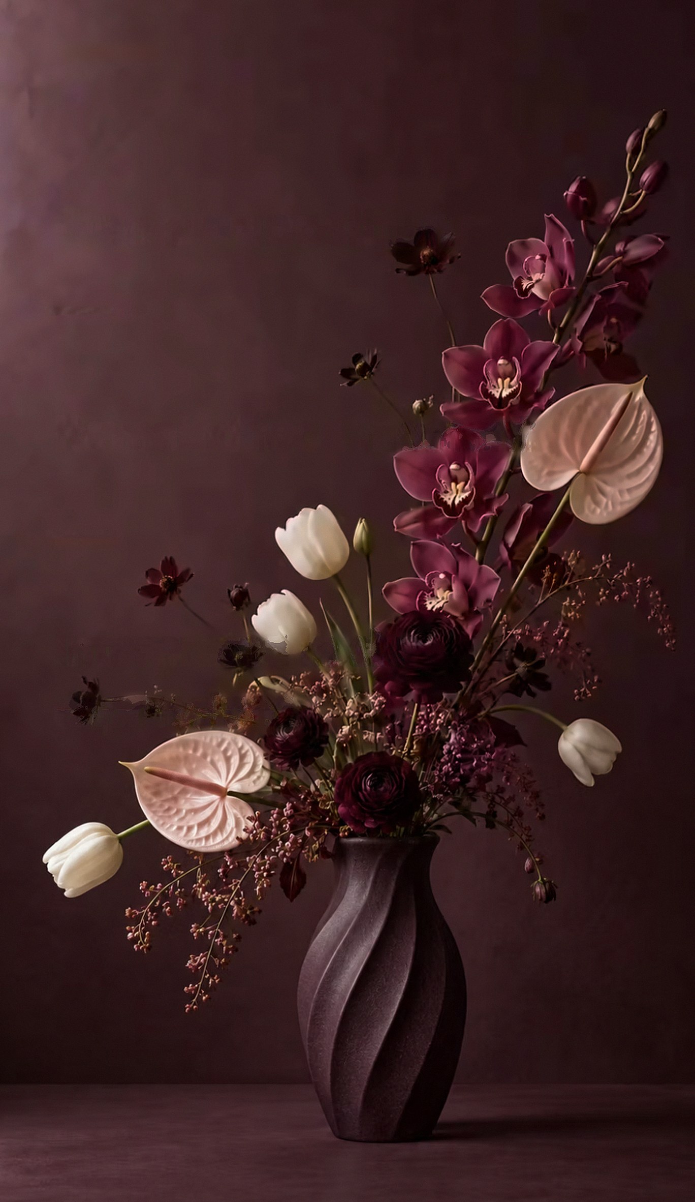 A twisted plum-coloured vase holding magenta orchids, blush anthuriums, white tulips and deep burgundy ranunculus against a mauve wall.