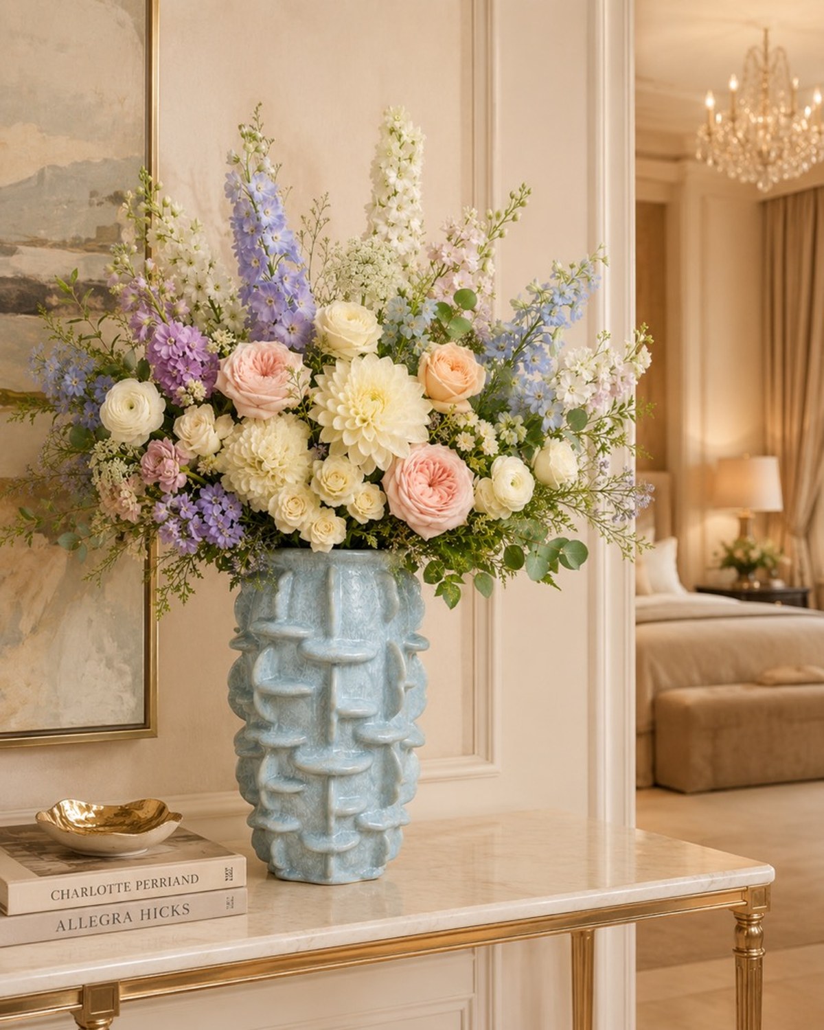 A pale blue textured ridged vase with lavender delphinium, cream dahlias and blush garden roses.