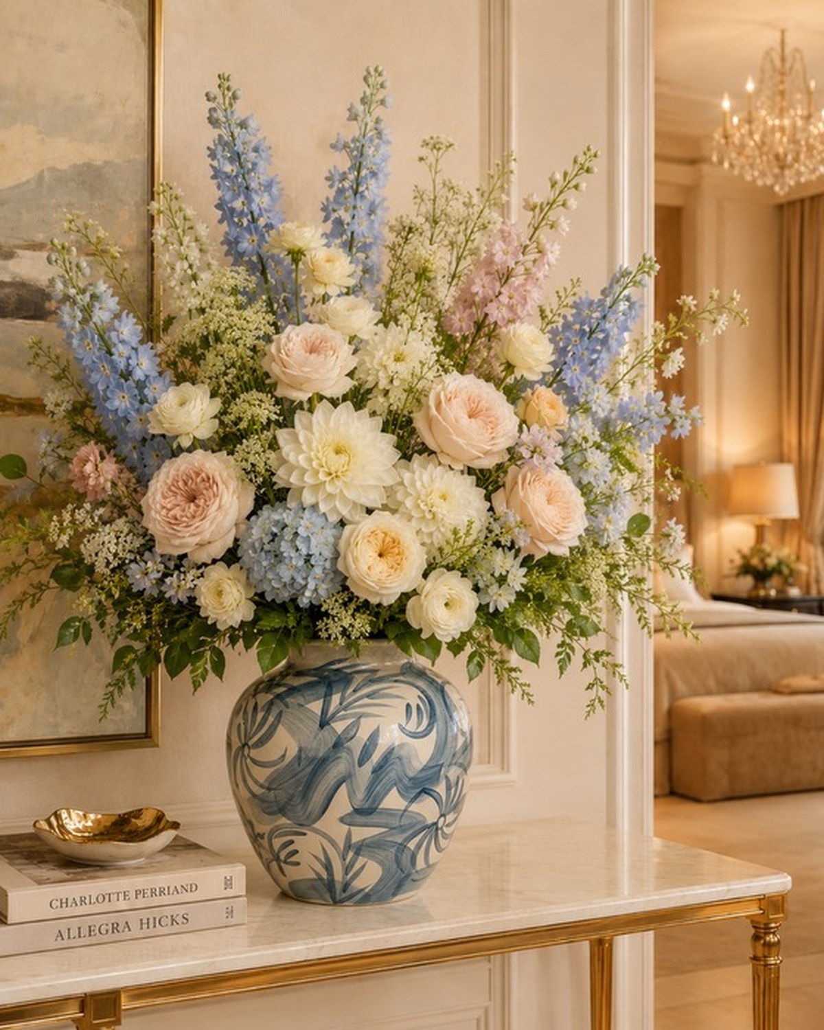 A white ribbed urn with handles holding blush garden roses and cream dahlias.